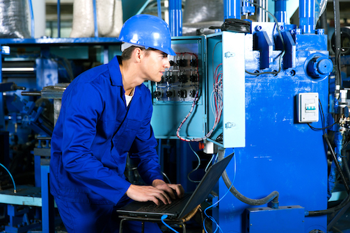 young electrician analyzing data on his laptop POWARE Industrial Automation engineer maakt software aanpassingen aan het PLC SCADA of DCS systeem